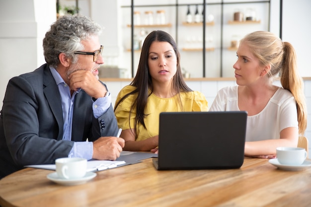 young-entrepreneurs-mature-investor-watching-presentation-discussing-project_74855-10462
